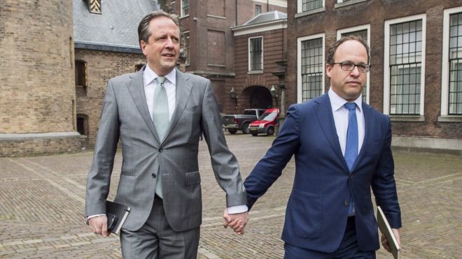 Dutch men hold hands to protest against homophobia