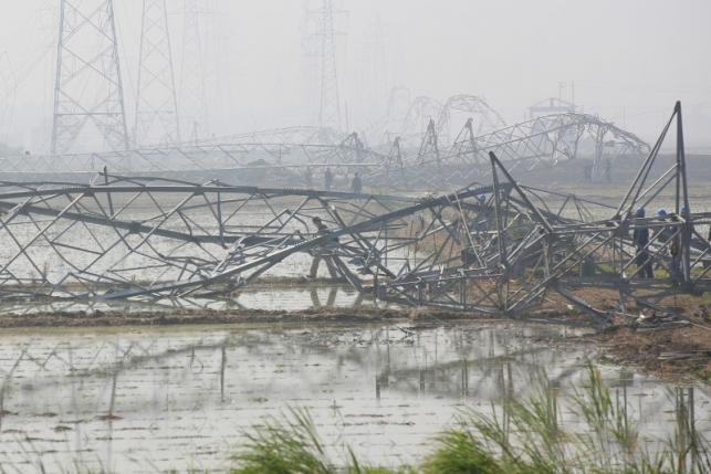 Rescue workers work on damaged high-voltage towers after a tornado hit Funing on Thursday, in Yancheng, Jiangsu province, June 25, 2016. REUTERS/Aly Song