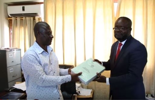 Samuel Tetteh, EC’s Director of Elections handing over the forms to Kofi Akpaloo