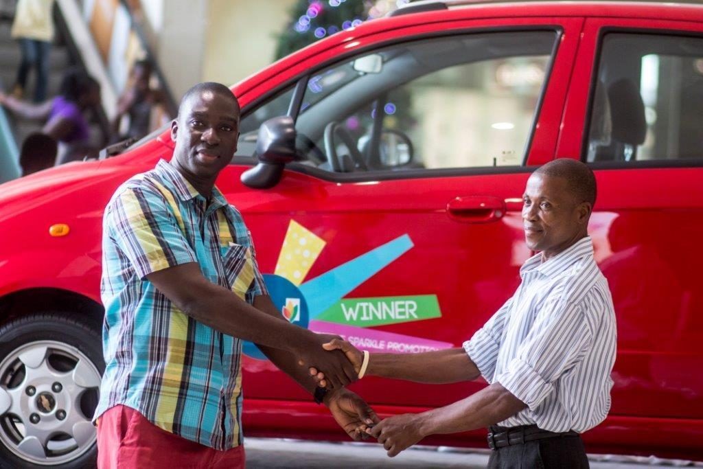 Michael Konadu, Marketing Manager at West Hills Mall congratulates Grand Prize Winner, Francis Mensah after giving him keys to the brand new Chevrolet Sparkle Lite Saloon car
