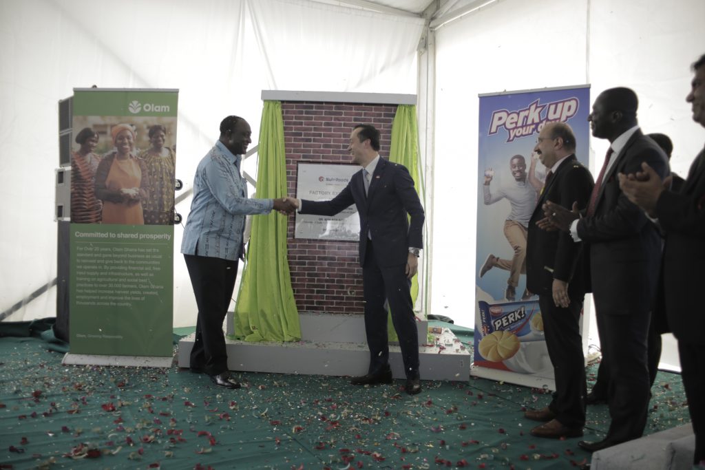 Mr. Alan Kyeremanten, Minister of Trade & Industry and his Singapore counterpart shake hands after unveiling a plaque to commemorate the opening of the expanded biscuit factory