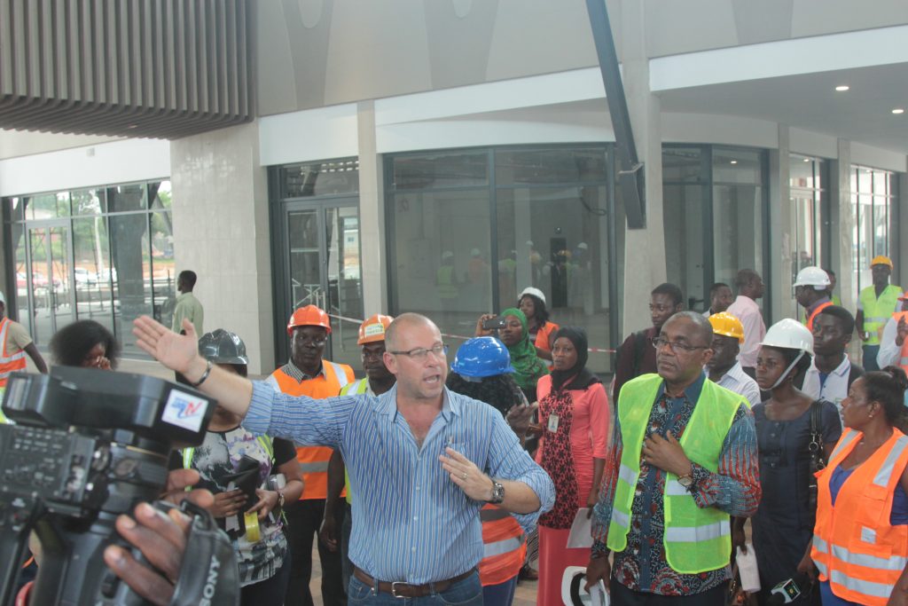Mr. Gerber explains a point about the architecture to journalists as Chairman Kofi Sekyere looks on during the facility tour of the Kumasi Press Corps