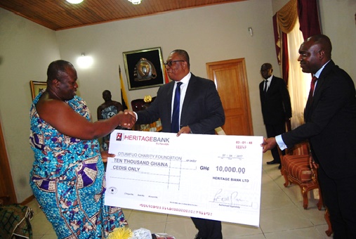 MD of Heritage Bank, Patrick E. Fiscian (in the middle) and General Manager for Retail Banking, Mark Achiampong presenting a cheque to the Otumfuo Charity Foundation.