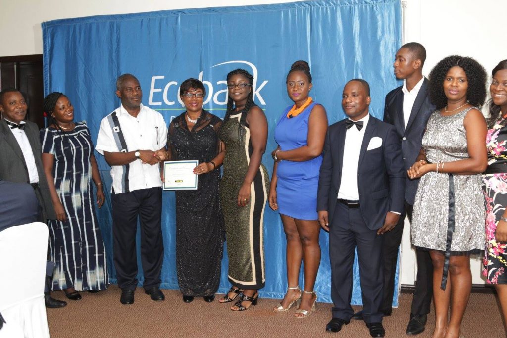 mr-ofei-agyekum-head-retail-operations-ecobank-in-white-presenting-one-of-the-numerous-awards-to-gn-banks-hilda-malm-general-manager-remittances-diaspora-services-holding-the-certifica