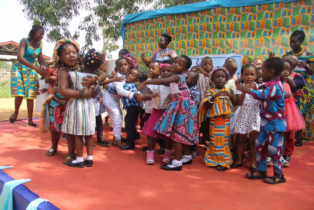 School children embrace each other in a show of good neighbourliness