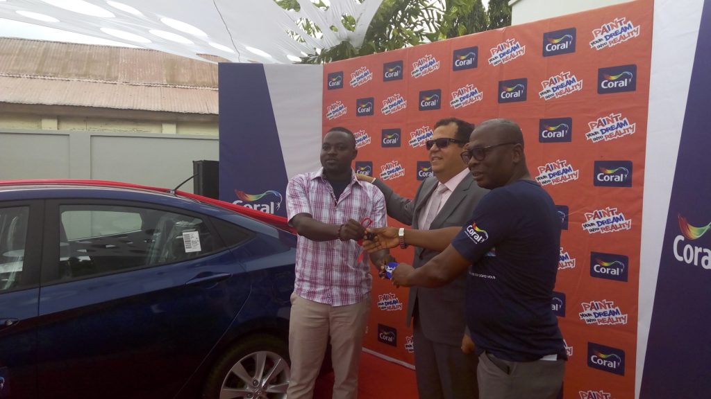 Francis Karikari Owusu left receiving the car key from Yaw Boamah Sarpong, General Manager of Coral Paints
